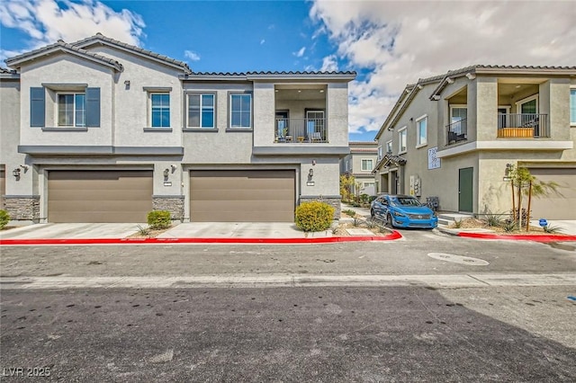 view of property with concrete driveway, an attached garage, stone siding, and stucco siding