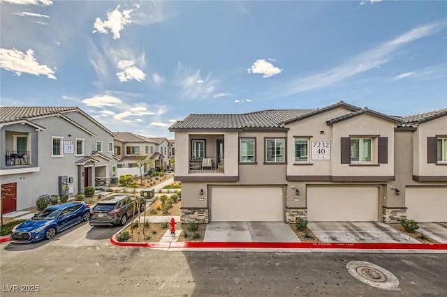 multi unit property featuring stucco siding, stone siding, a residential view, and driveway