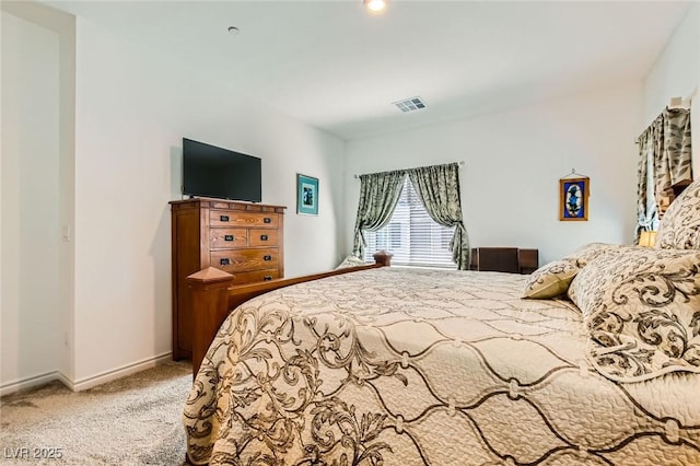 carpeted bedroom with visible vents and baseboards