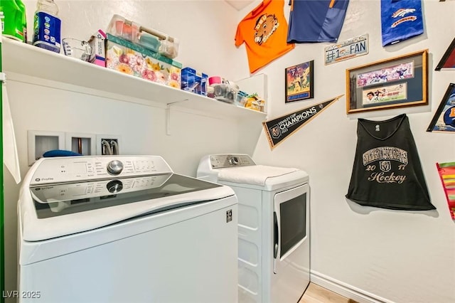 clothes washing area featuring laundry area and separate washer and dryer