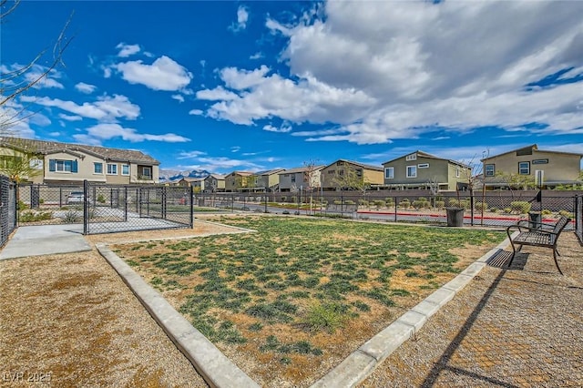 view of yard featuring fence and a residential view