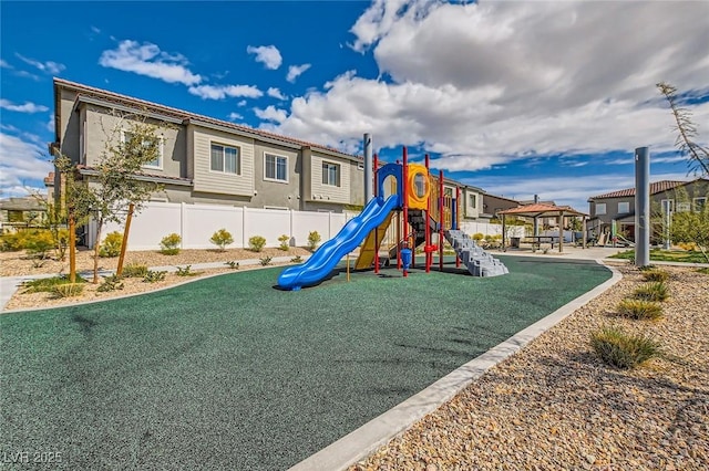 community playground featuring a gazebo, a residential view, and fence