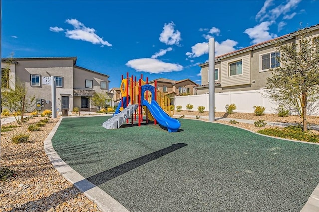 communal playground with fence and a residential view