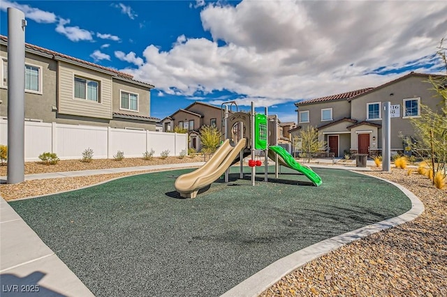 community jungle gym featuring fence and a residential view