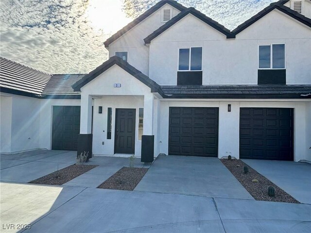 384 E Erin St Unit 3, Pahrump, NV 89048 - view of front facade featuring a garage, driveway, and stucco siding