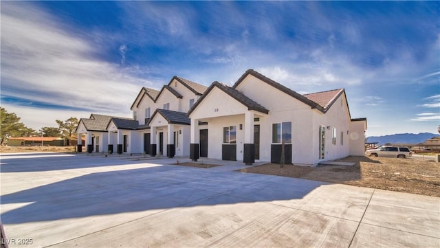 view of front of home featuring a tiled roof and stucco siding