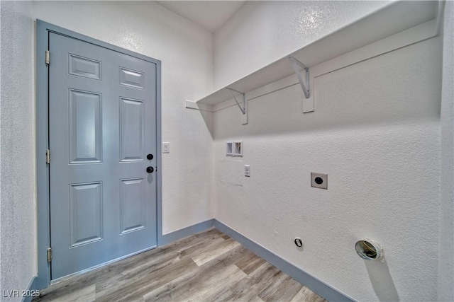 clothes washing area featuring hookup for a washing machine, light wood-style flooring, hookup for an electric dryer, laundry area, and baseboards