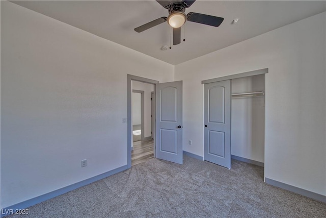 unfurnished bedroom featuring ceiling fan, a closet, carpet, and baseboards