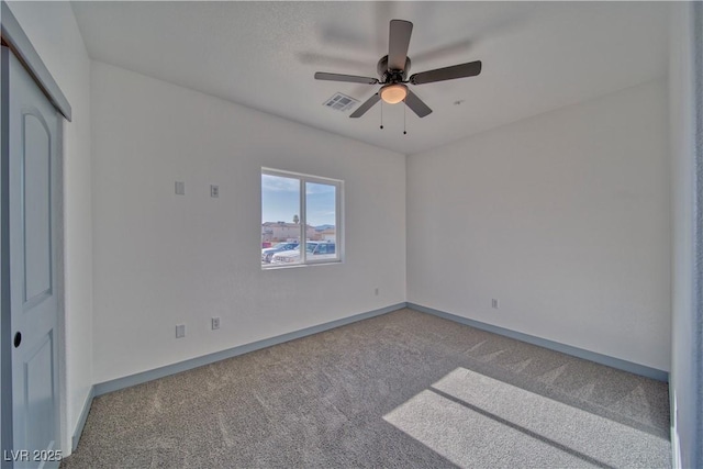 unfurnished bedroom featuring baseboards, visible vents, ceiling fan, and carpet flooring