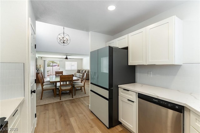 kitchen featuring light stone counters, light wood finished floors, freestanding refrigerator, white cabinetry, and dishwasher