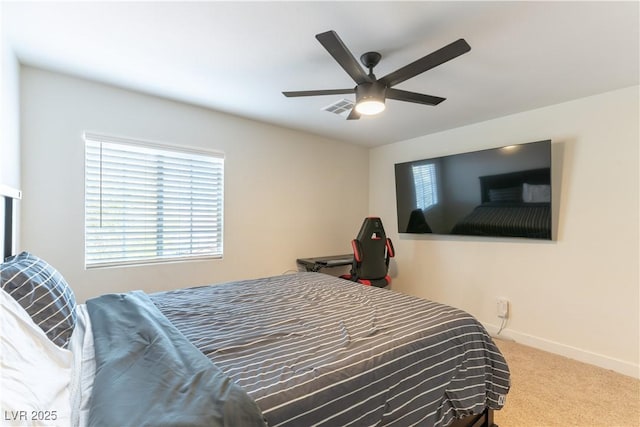 carpeted bedroom featuring visible vents, baseboards, and a ceiling fan