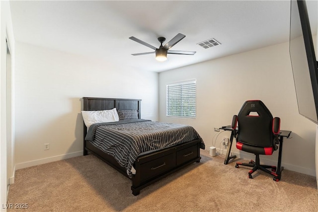 bedroom featuring baseboards, visible vents, ceiling fan, and light colored carpet