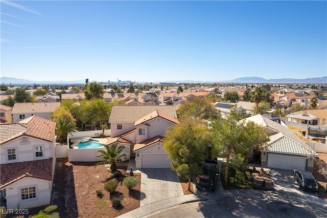 drone / aerial view featuring a residential view and a mountain view