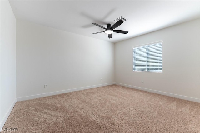 unfurnished room featuring visible vents, baseboards, a ceiling fan, and light colored carpet