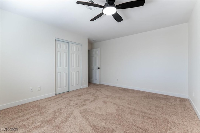 unfurnished bedroom featuring a ceiling fan, a closet, baseboards, and carpet flooring