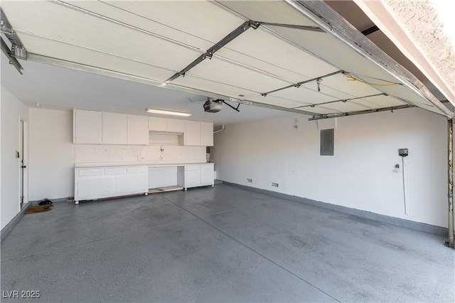 garage with baseboards, electric panel, and a garage door opener