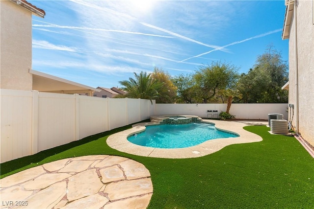 view of pool featuring a pool with connected hot tub, a patio area, and a fenced backyard