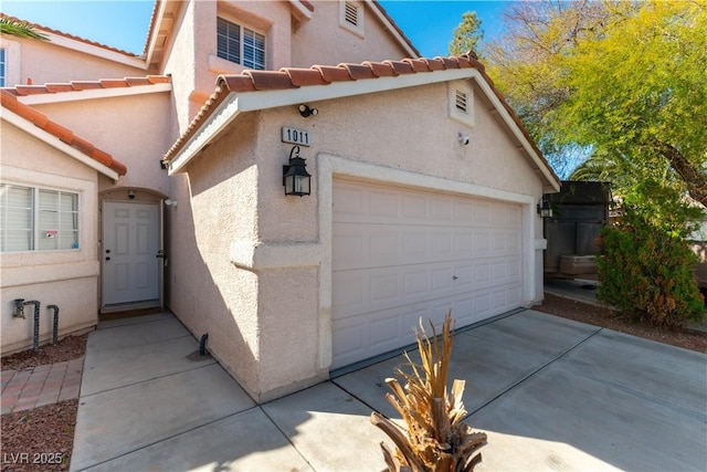 garage with concrete driveway