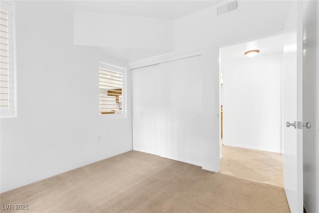 unfurnished room featuring visible vents and carpet floors