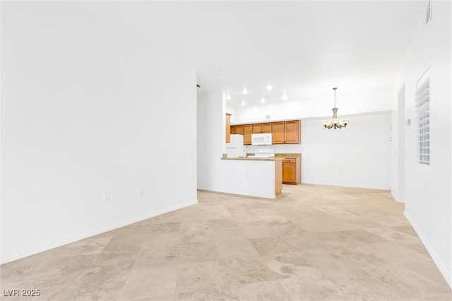 unfurnished living room with baseboards and an inviting chandelier