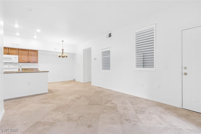 unfurnished living room with a notable chandelier, recessed lighting, and visible vents