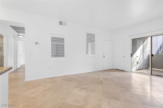 empty room featuring visible vents and baseboards