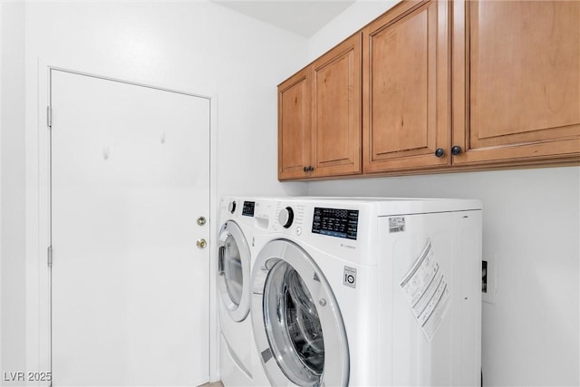 laundry area with separate washer and dryer and cabinet space