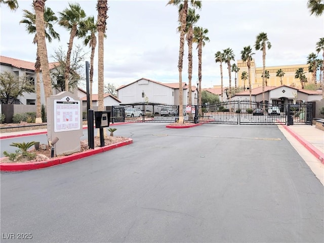 view of road with a gated entry, a residential view, and a gate