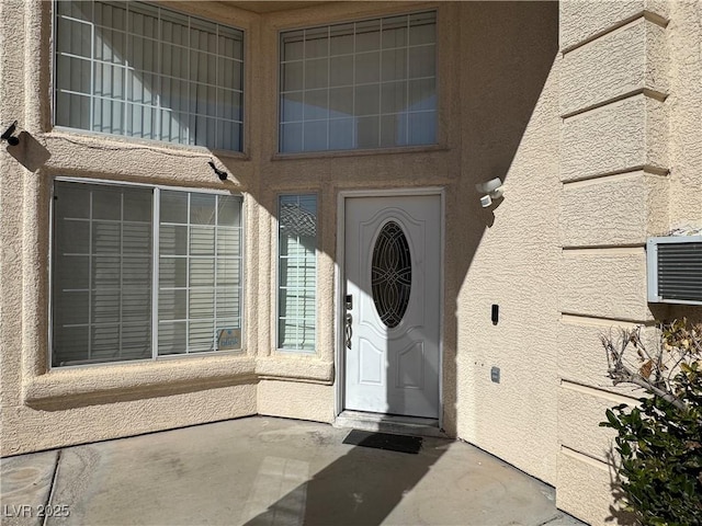 property entrance with stucco siding