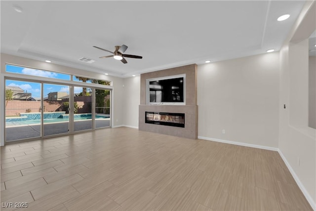 unfurnished living room with recessed lighting, a large fireplace, a ceiling fan, visible vents, and baseboards