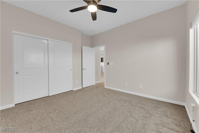 unfurnished bedroom with a ceiling fan, a closet, baseboards, and carpet flooring