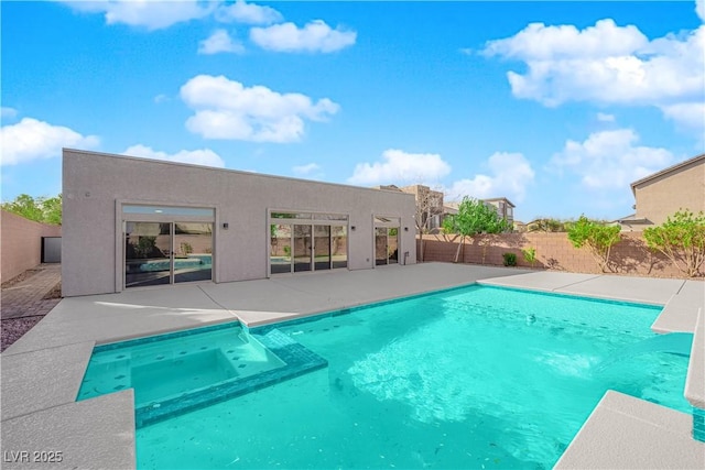 view of pool featuring a pool with connected hot tub, a fenced backyard, and a patio