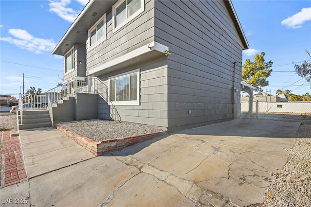 view of home's exterior with fence