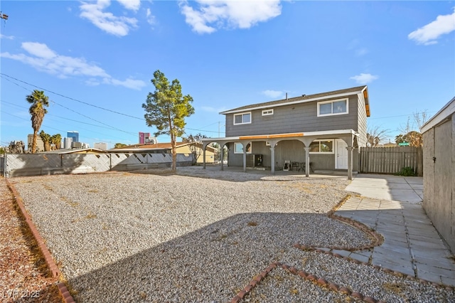 back of house featuring a patio and a fenced backyard