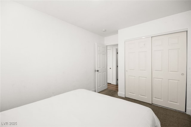 bedroom featuring a closet and dark carpet