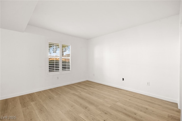 unfurnished room featuring light wood-type flooring and baseboards