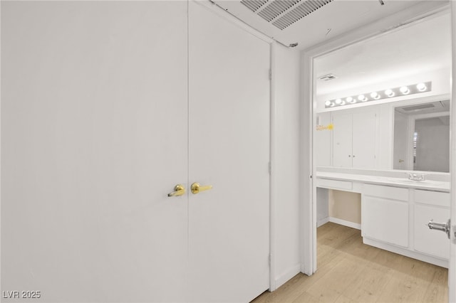 bathroom with vanity and wood finished floors