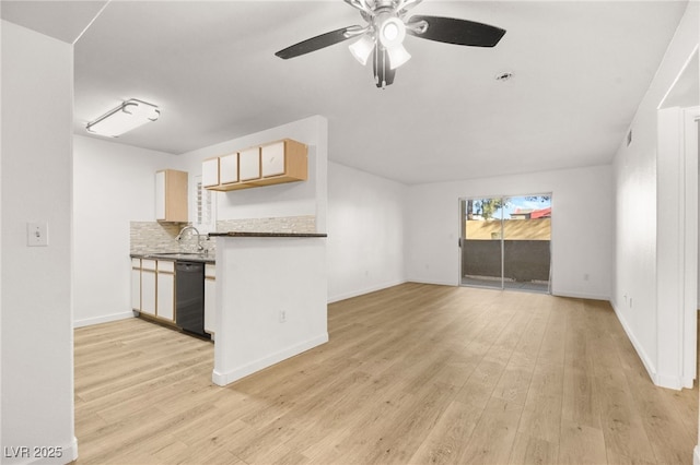 kitchen featuring light wood-type flooring, a sink, backsplash, and dishwasher