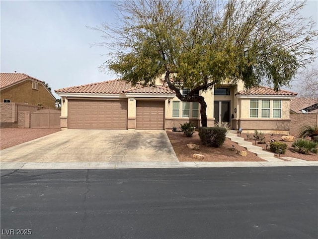 view of front of house featuring a garage, fence, concrete driveway, and stucco siding