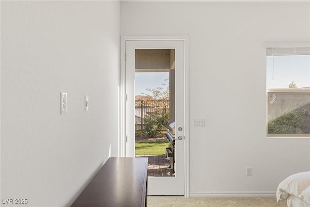 entryway featuring baseboards and carpet flooring