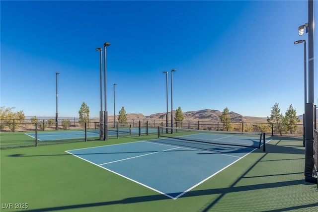 view of sport court with community basketball court, fence, and a mountain view