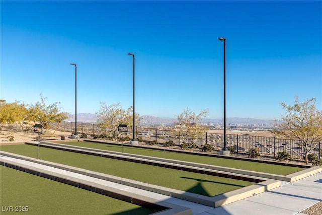 view of home's community with fence and a mountain view