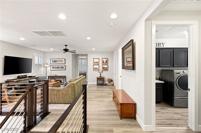 interior space with light wood finished floors, washer / dryer, visible vents, and recessed lighting