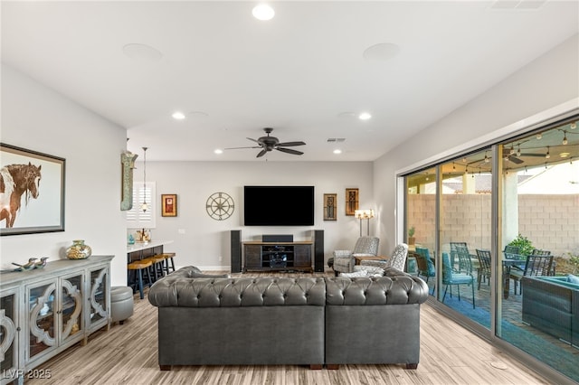 living area featuring ceiling fan, recessed lighting, visible vents, and light wood-style floors