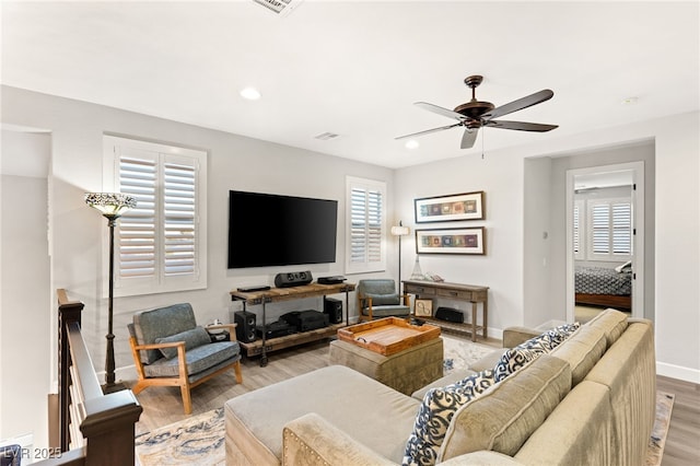 living area featuring light wood-style floors, baseboards, a ceiling fan, and recessed lighting