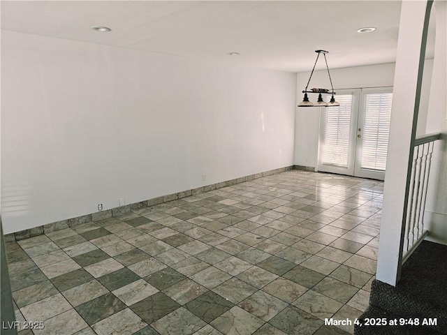 unfurnished dining area featuring french doors, recessed lighting, and baseboards