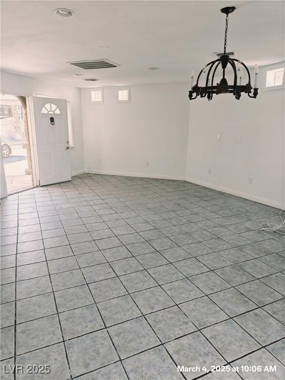 interior space featuring visible vents, baseboards, and light tile patterned floors