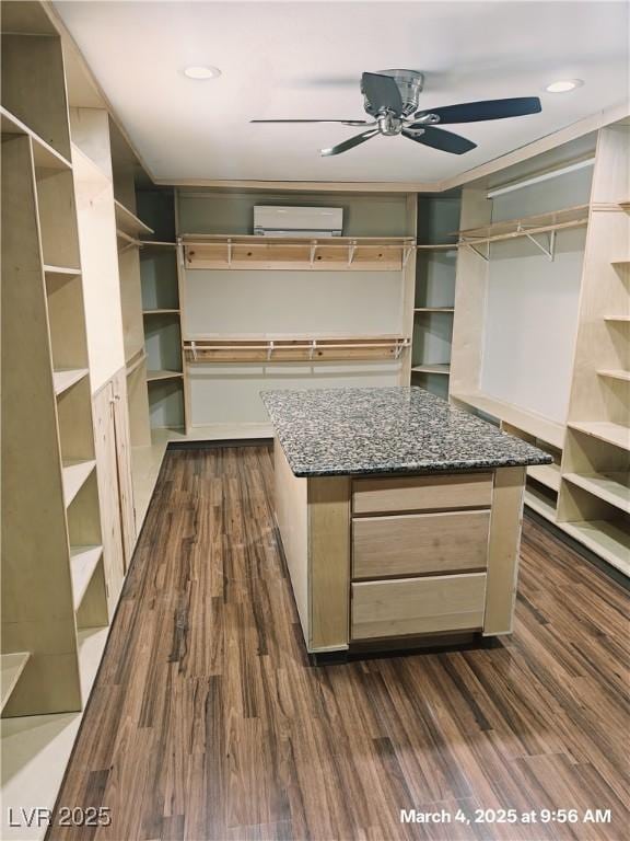 walk in closet featuring dark wood finished floors and a ceiling fan