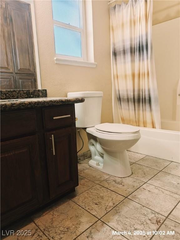 bathroom featuring shower / bath combo with shower curtain, tile patterned flooring, vanity, and toilet