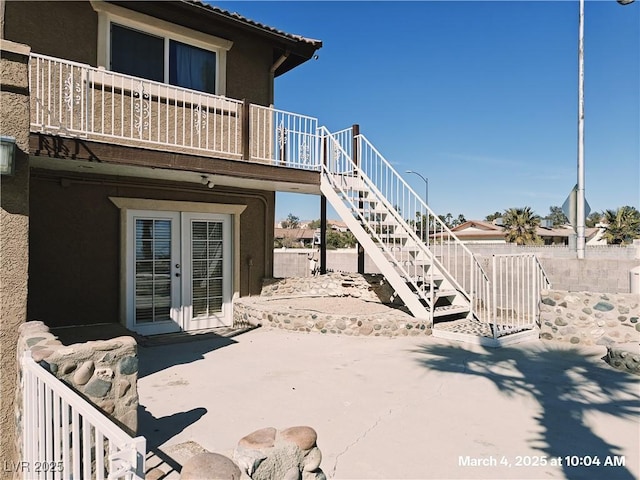 view of patio / terrace with stairs, fence, and french doors